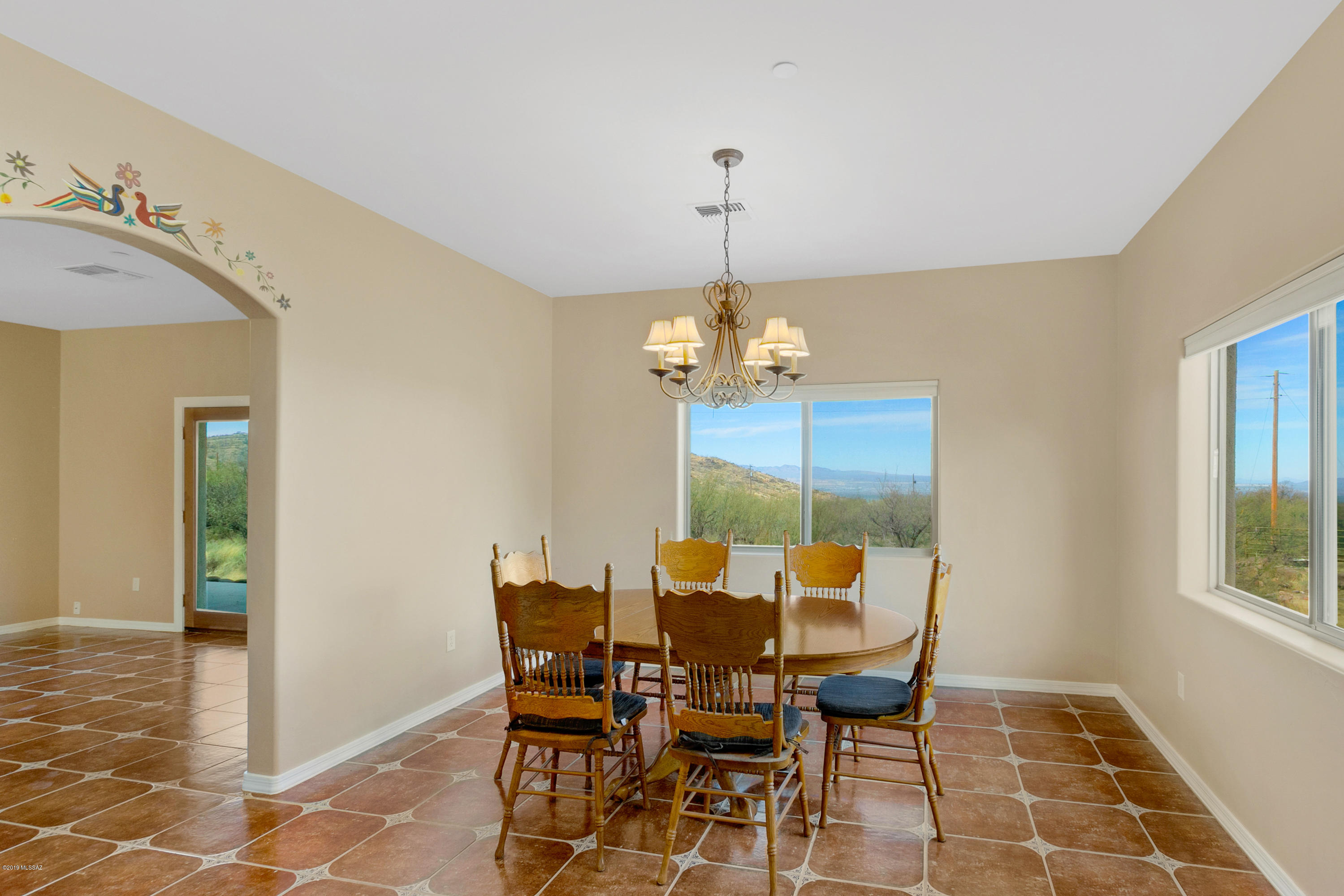 21960 South Helvetia Road Sahuarita, AZ 85629 - Photo 10 of 29 a view of a dining room with furniture and chandelier