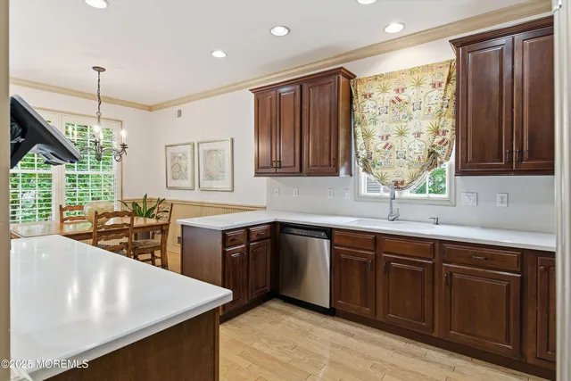 a kitchen with stainless steel appliances granite countertop sink stove and refrigerator