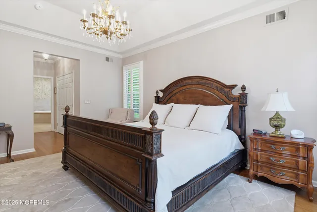a bedroom with a bed and a chandelier