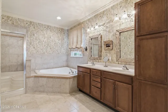 a bathroom with a double vanity sink toilet mirror and shower