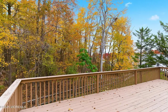 a view of balcony with wooden floor and fence