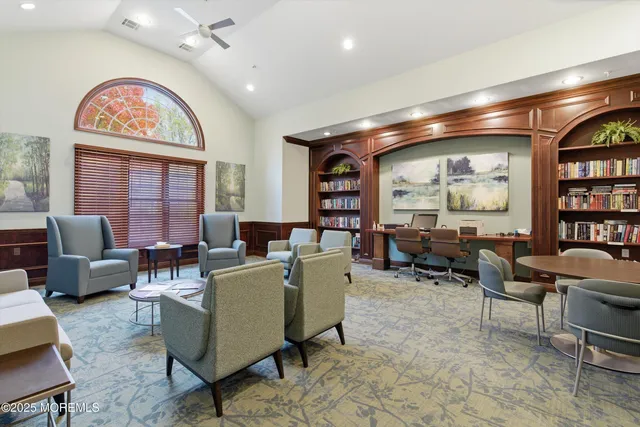 a living room with furniture a rug and a large window
