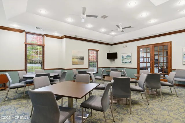 a view of a dining room with furniture next to a large window