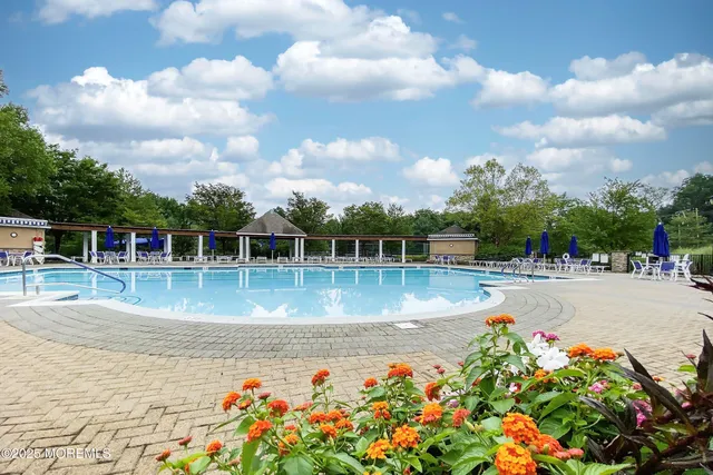 a view of swimming pool with sitting area