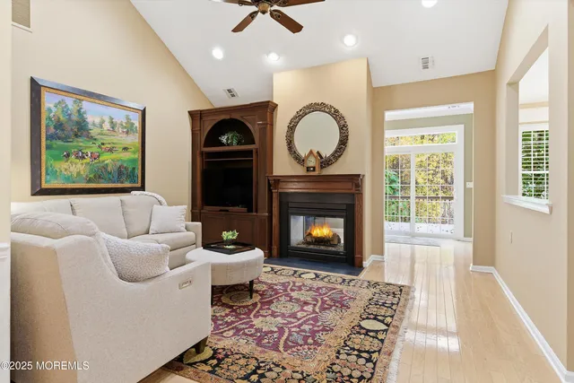a living room with furniture a window and a fireplace
