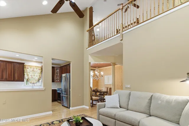 a living room with furniture and a ceiling fan