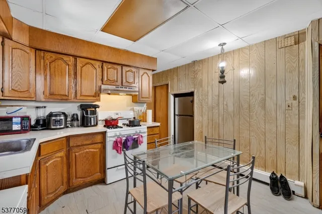 a kitchen with stainless steel appliances granite countertop a refrigerator and cabinets