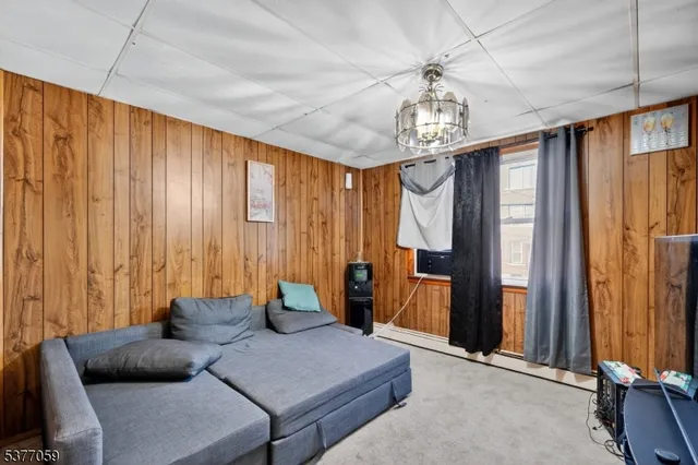 a living room with furniture and a chandelier
