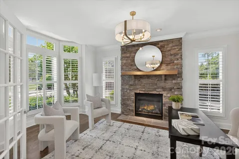 a living room with furniture a window and a fireplace