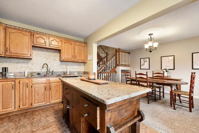 a kitchen that has a lot of cabinets a sink and dishwasher in it