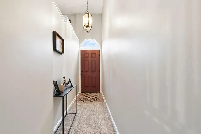 en empty room with wooden floor and glass door
