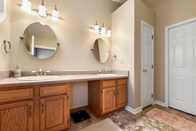 a bathroom with a double vanity sink and a mirror