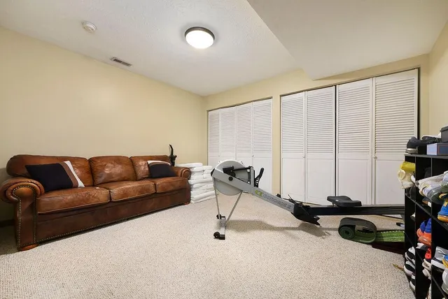 a living room with furniture a air conditioner and a window