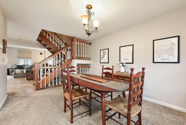 a view of a dining room with furniture and stairs