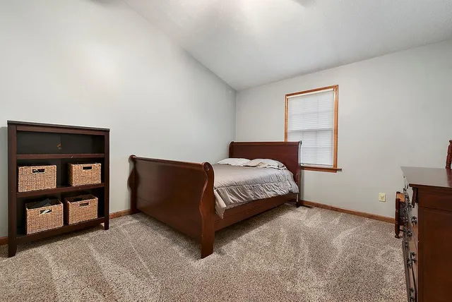 a bedroom with a bed and a night stand