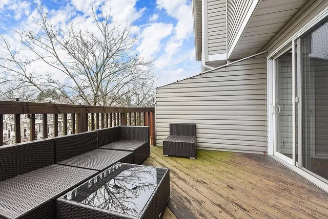 a view of a roof deck with wooden floor and fence