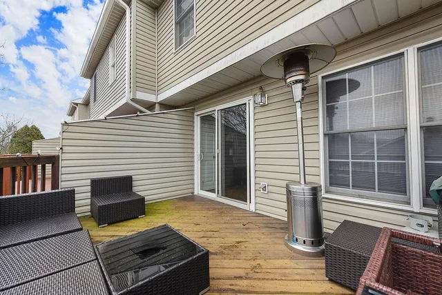 a view of a deck with two couches chairs and wooden floor