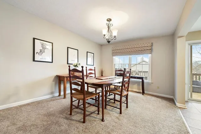 a view of a dining room with furniture and window