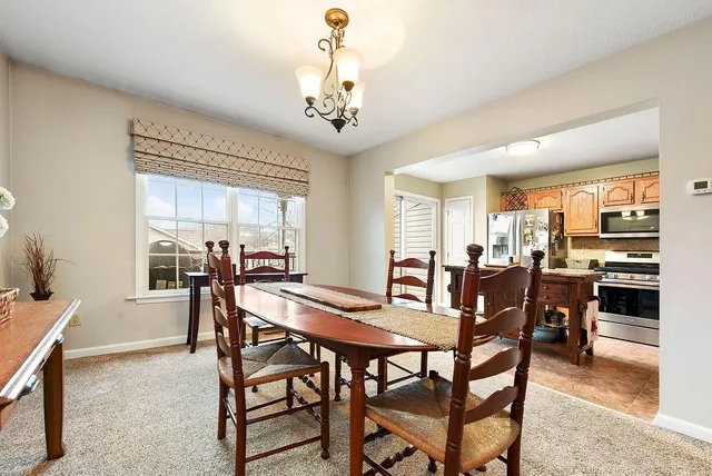 a view of a dining room with furniture and a chandelier