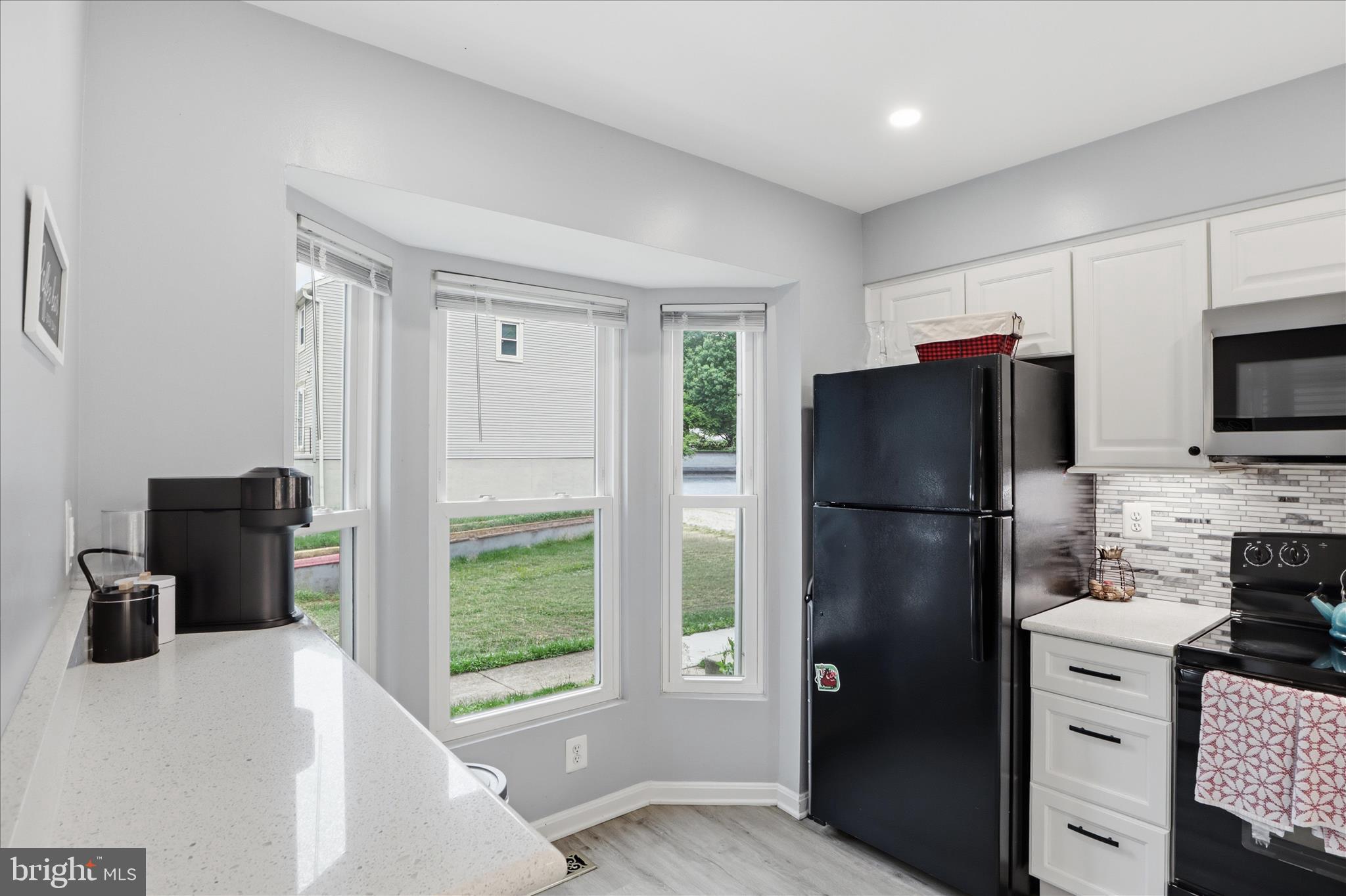 71 Kinsman View Circle Silver Spring, MD 20901 - Photo 10 of 42 a kitchen with a refrigerator a stove a microwave a sink and a refrigerator