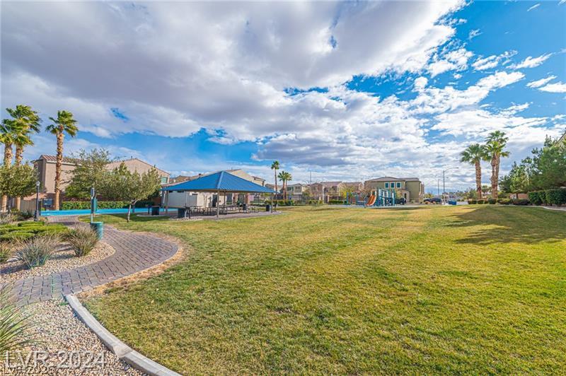 9056 Tony Ridge Avenue Las Vegas, NV 89148 - Photo 31 of 32 Green space abounds, with a covered picnic area and playground providing community recreation.