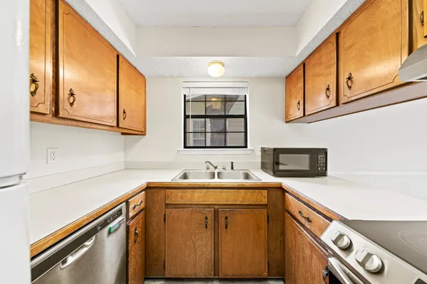 a kitchen with a sink cabinets and a wooden floor