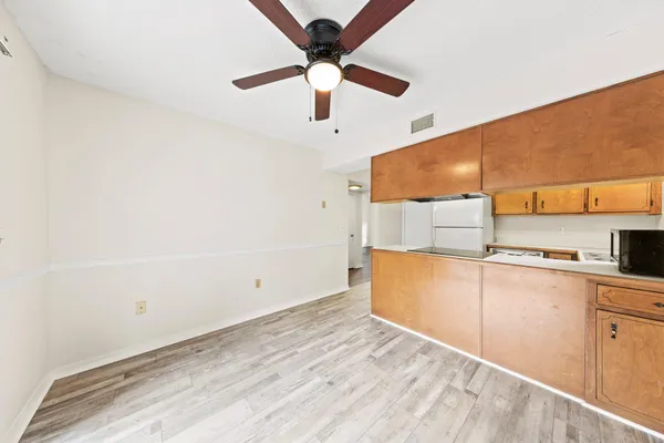 a kitchen with stainless steel appliances a refrigerator and microwave