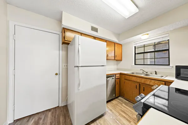 a kitchen with stainless steel appliances granite countertop a refrigerator and a sink