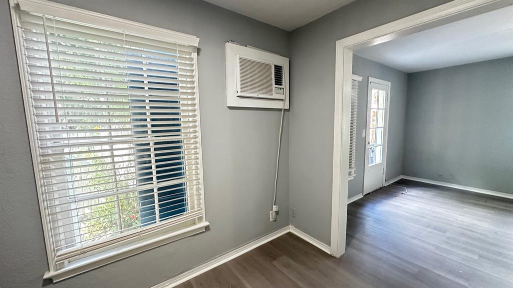 325 North Federal Highway, Unit 2 Lake Worth Beach, FL 33460 - Photo 6 of 10 a view of an empty room with wooden floor and a window
