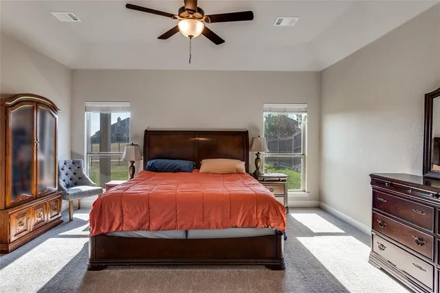 a bedroom with a bed lamps and window