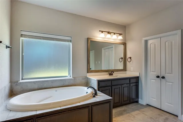 a bathroom with a tub and a sink