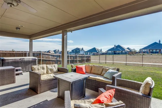 a roof deck with couches and potted plants