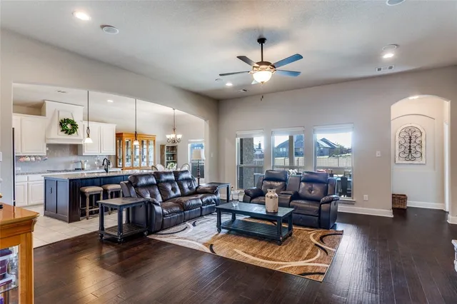 a living room with fireplace furniture and wooden floor