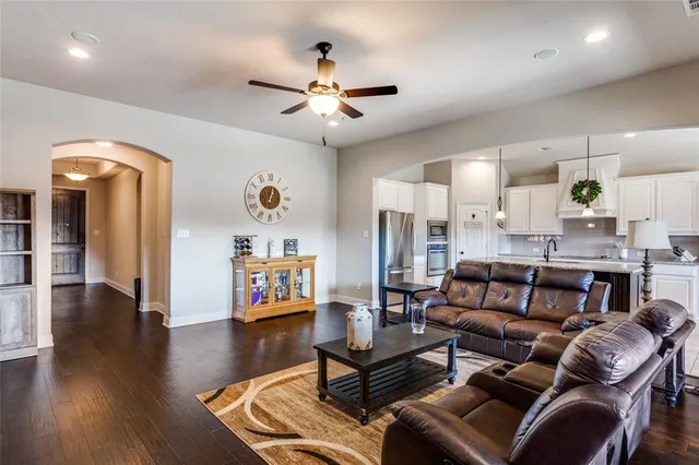 a living room with furniture and a chandelier