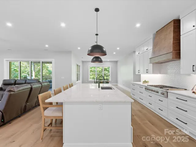a kitchen with stainless steel appliances granite countertop white cabinets sink and dishwasher