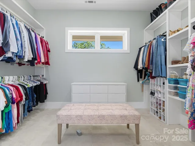 a bedroom with furniture a bed and a baby crib