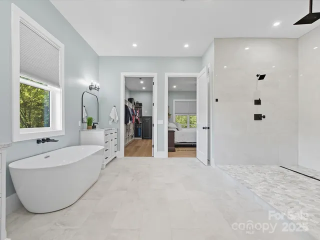 a bed room with a bed and painting on the wall