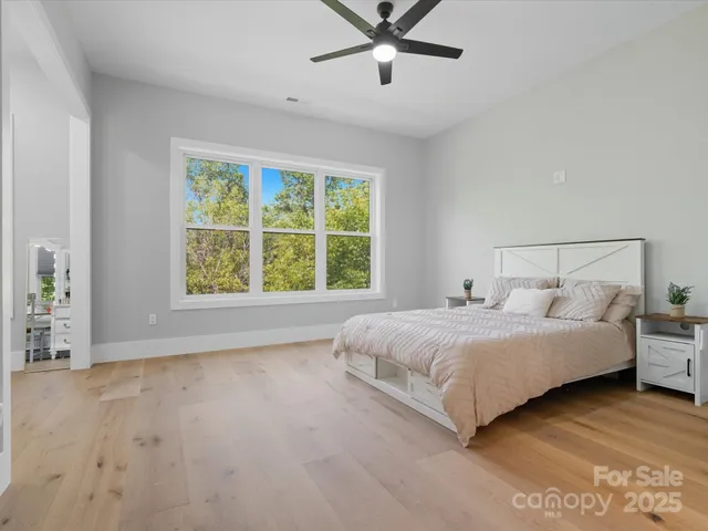 a bathroom with a granite countertop toilet sink and mirror