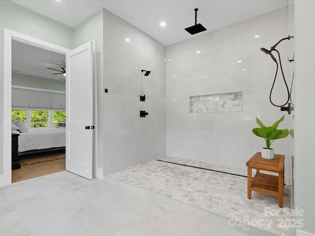 a kitchen with a stove a refrigerator and a dining table with wooden floor