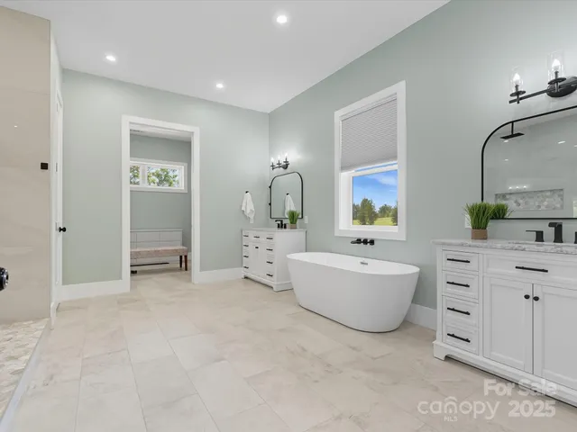 an aerial view of a house with swimming pool and outdoor seating