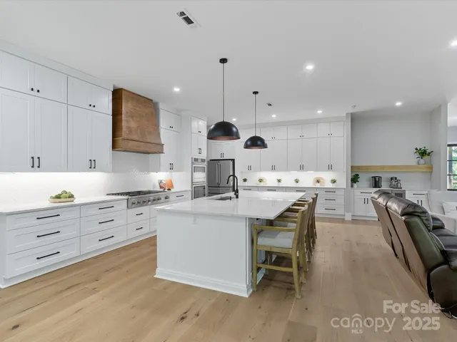 a spacious bathroom with a double vanity sink a mirror a next to a window