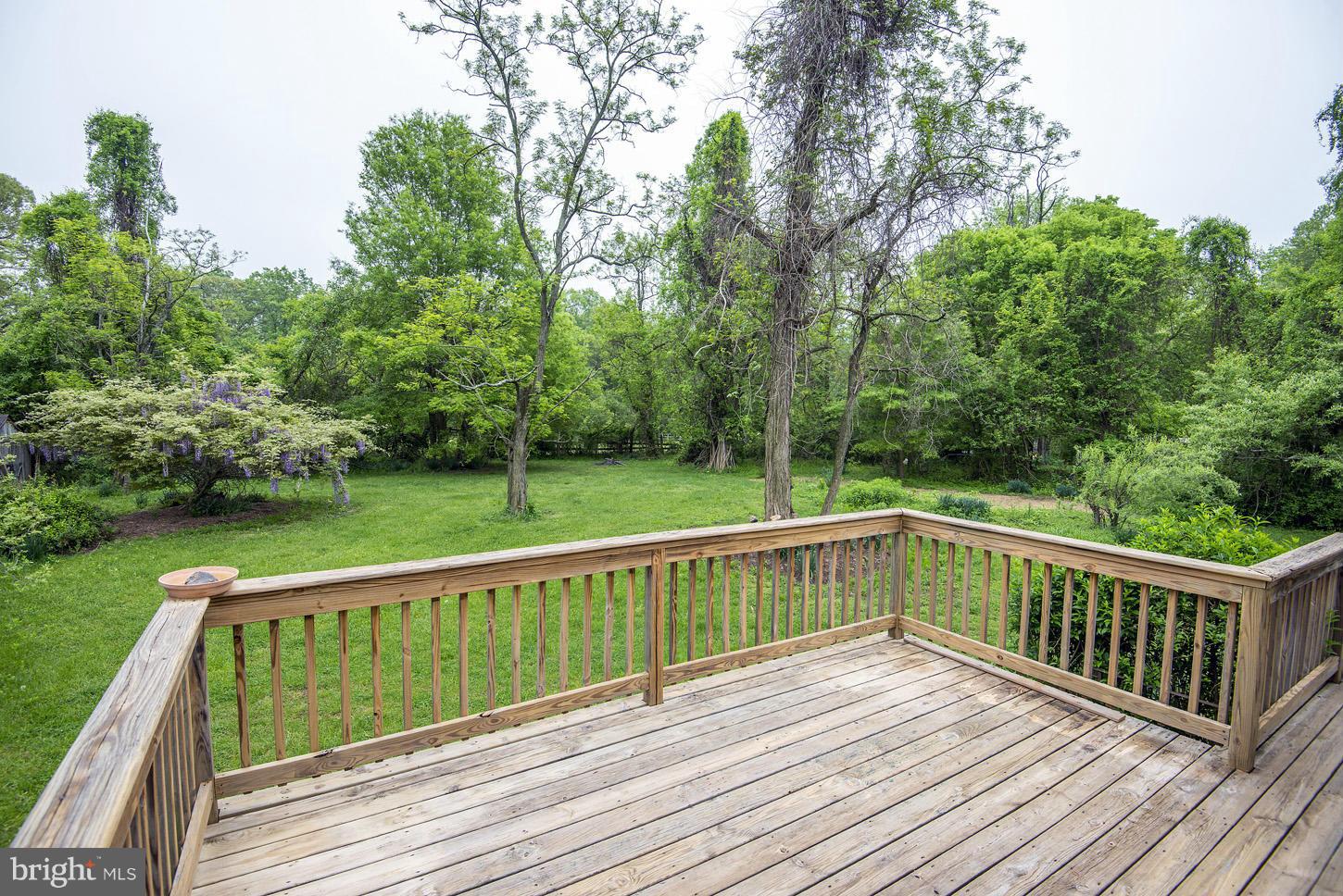 16110 Accolawn Road Accokeek, MD 20607 - Photo 7 of 20 a view of deck with wooden floor and fence next to a yard