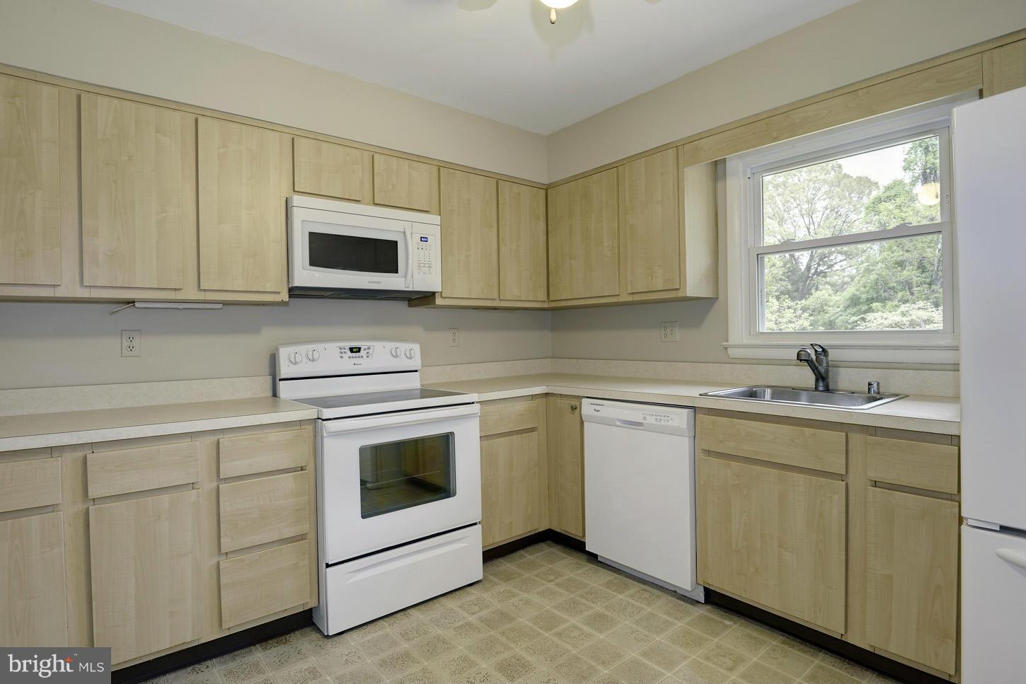 16110 Accolawn Road Accokeek, MD 20607 - Photo 8 of 20 a kitchen with white cabinets appliances and a sink