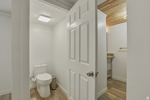 500 North 800 East Springville, UT 84663 - Photo 22 of 51 Half bathroom with light wood-style floors, a textured wall, and vanity