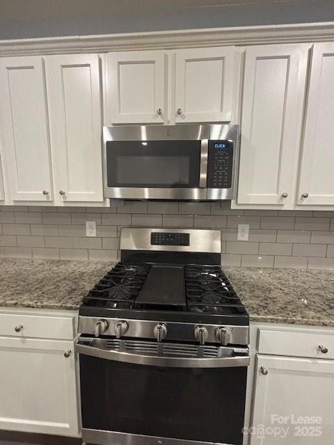 118 Quinn Road Matthews, NC 28104 - Photo 22 of 29 a kitchen with granite countertop white cabinets and black appliances