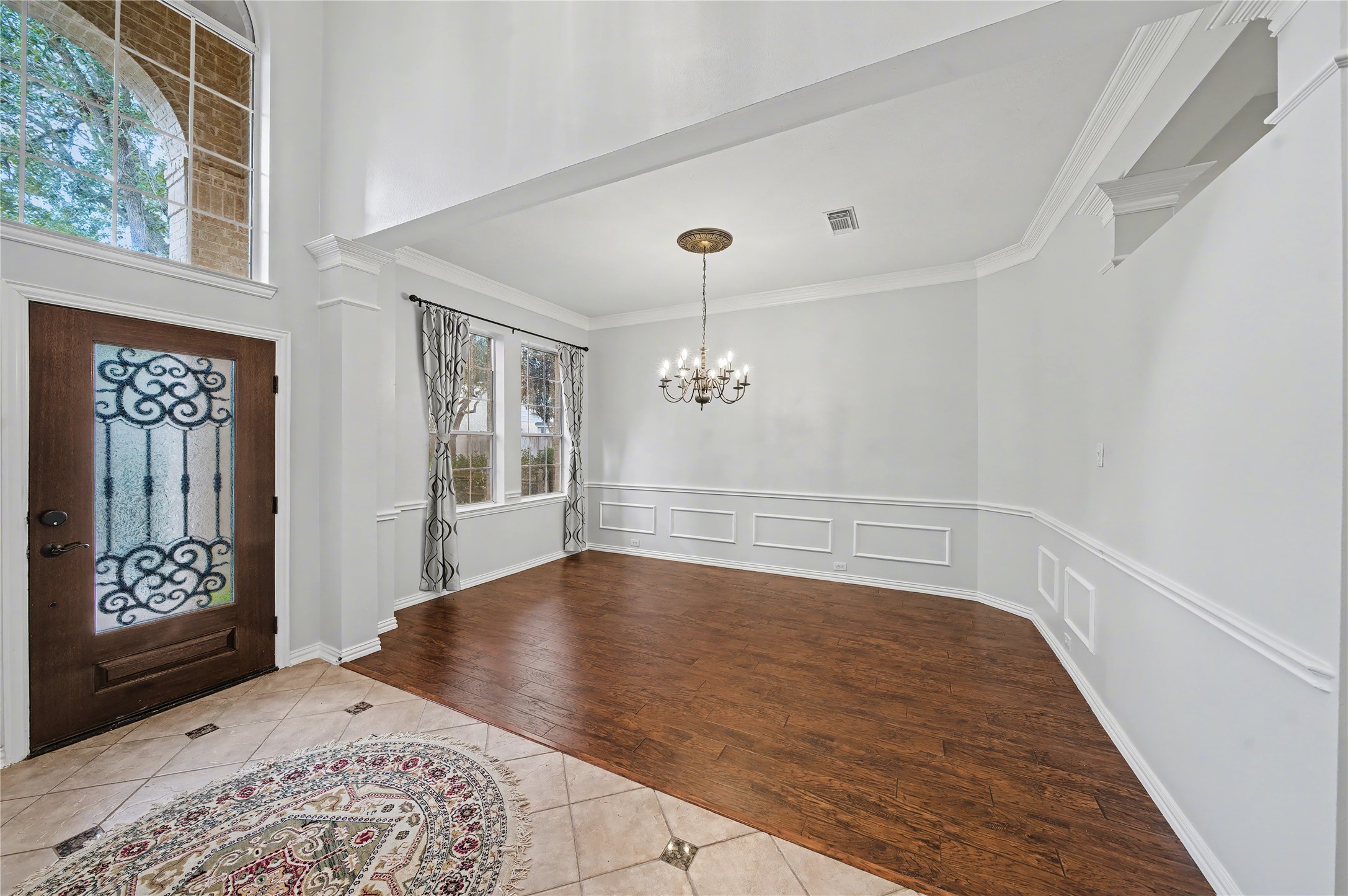 5403 Emerald Pointe Lane Sugar Land, TX 77479 - Photo 8 of 50 a view of an empty room with chandelier and wooden floor