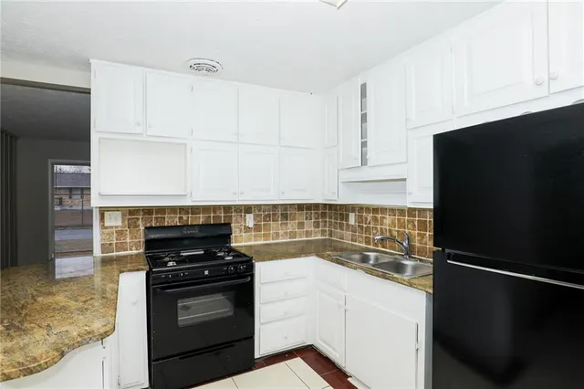a kitchen with a refrigerator and a sink