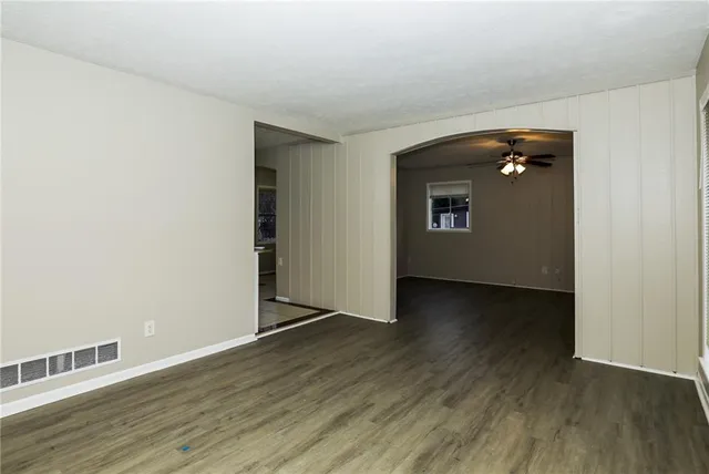 an empty room with wooden floor and closet