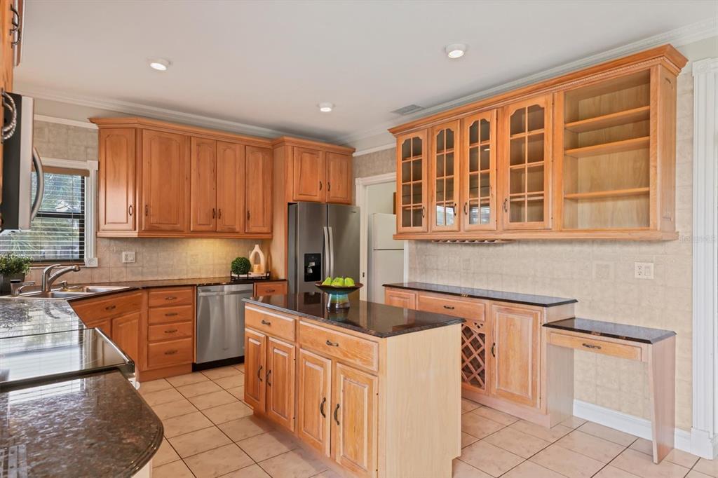 133 Inlets Boulevard, Unit 133 Nokomis, FL 34275 - Photo 11 of 63 a kitchen with stainless steel appliances granite countertop a stove a sink and a refrigerator