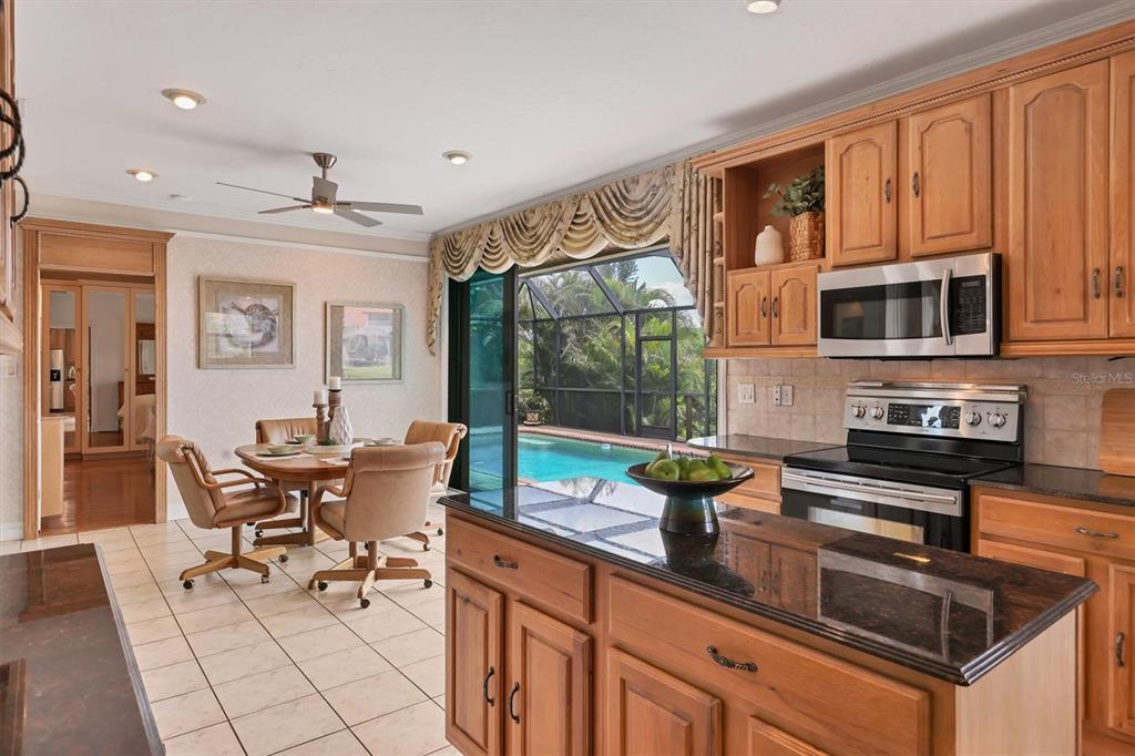 133 Inlets Boulevard, Unit 133 Nokomis, FL 34275 - Photo 12 of 63 a kitchen with a sink and a stove top oven